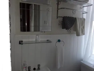 a bathroom with a sink and a mirror at Stafford House in Blackpool