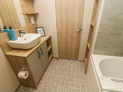 a bathroom with a sink and a bath tub at Barney's Retreat in Carnforth