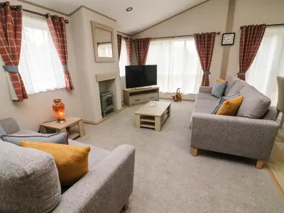 a living room with two couches and a tv at Barney's Retreat in Carnforth