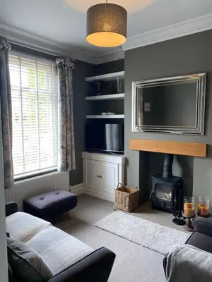 a living room with a tv and a fireplace at Cheerful and spacious 3 bed home in Clitheroe in Clitheroe