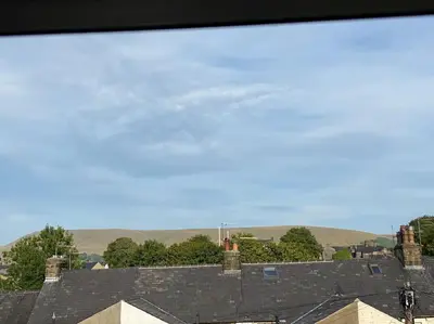 a view of roofs of houses with hills in the background at Cheerful and spacious 3 bed home in Clitheroe in Clitheroe