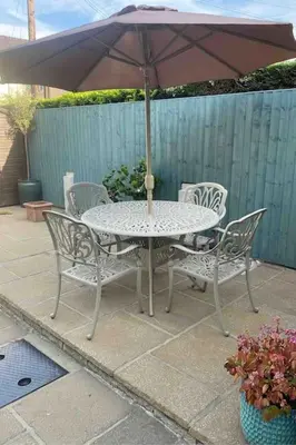 a table and chairs with an umbrella on a patio at Cheerful and spacious 3 bed home in Clitheroe in Clitheroe