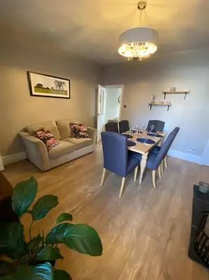 a living room with a table and chairs and a couch at Cheerful and spacious 3 bed home in Clitheroe in Clitheroe