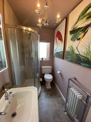 a bathroom with a shower and a toilet and a sink at Cheerful and spacious 3 bed home in Clitheroe in Clitheroe