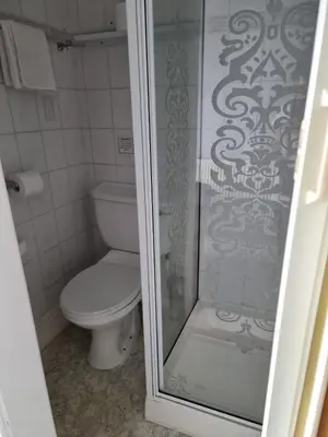 a bathroom with a toilet and a glass shower at Casablanca in Blackpool