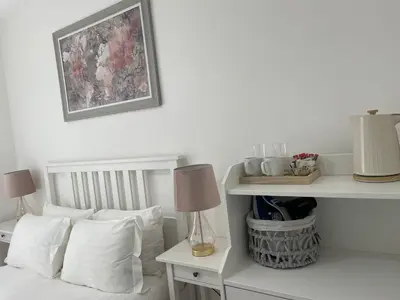 a white bedroom with a bed with white pillows at CityBreaks Rooms with Free Parking in Liverpool