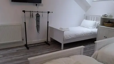 a room with two beds and an umbrella hanging on the wall at CityBreaks Rooms with Free Parking in Liverpool