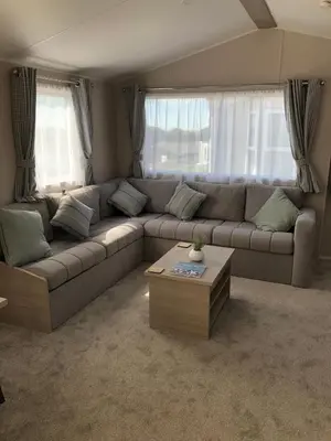 a living room with a couch and a coffee table at Tranquility No 42 Port Haverigg Marina in Millom