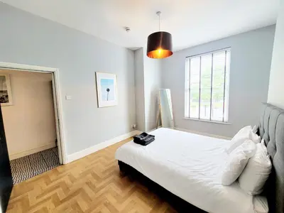 a bedroom with a white bed and a window at Beautiful Georgian Mansion! by City Sparrow in Liverpool