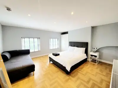 a large bedroom with a bed and a couch at Beautiful Georgian Mansion! by City Sparrow in Liverpool
