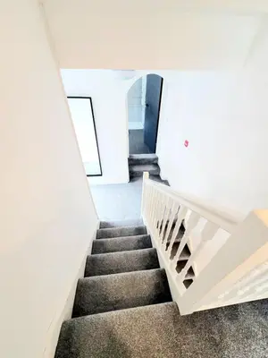 a staircase in a white house with a stair case at Beautiful Georgian Mansion! by City Sparrow in Liverpool