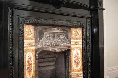 an ornate black fireplace with gold and orange glass at Lancefield House - Air Host & Stay - 5 Bedroom Sleeps 15 in Walton on the Hill