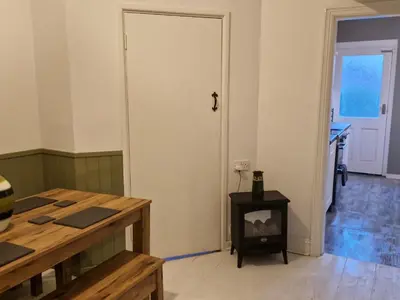 a room with a white door and a stove at Three Bedroomed House in Morecambe in Morecambe