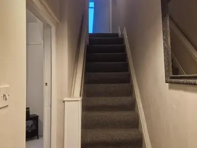 a staircase in a house with a blue light at Three Bedroomed House in Morecambe in Morecambe