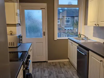 a kitchen with a sink and a window at Three Bedroomed House in Morecambe in Morecambe