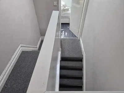 a staircase in a room with a stair case at Three Bedroomed House in Morecambe in Morecambe