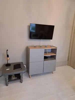 a entertainment center with a tv on a wall at Three Bedroomed House in Morecambe in Morecambe