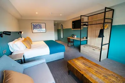 a hotel room with a bed and a couch at The Lake House in Liverpool