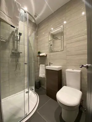 a bathroom with a toilet and a glass shower at Modern 3 bedroom apartment close to the city centre in Liverpool