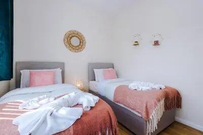 a bedroom with two beds with towels on them at Liverpool 4 Bed! Sleeps 9! Groups and Contractors! FREE OFF STREET PARKING! 3 Toilets! FREE WIFI! in West Derby