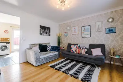 a living room with a couch and a chair at Liverpool 4 Bed! Sleeps 9! Groups and Contractors! FREE OFF STREET PARKING! 3 Toilets! FREE WIFI! in West Derby
