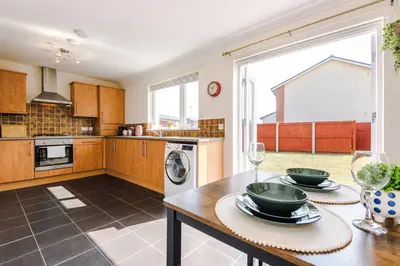 a kitchen with a table with two dishes on it at Liverpool 4 Bed! Sleeps 9! Groups and Contractors! FREE OFF STREET PARKING! 3 Toilets! FREE WIFI! in West Derby