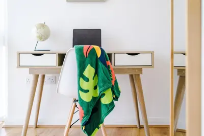 a blanket on a chair next to a desk at Liverpool 4 Bed! Sleeps 9! Groups and Contractors! FREE OFF STREET PARKING! 3 Toilets! FREE WIFI! in West Derby