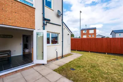 an open door of a house with a yard at Liverpool 4 Bed! Sleeps 9! Groups and Contractors! FREE OFF STREET PARKING! 3 Toilets! FREE WIFI! in West Derby