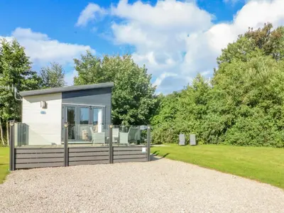 a tiny house in a garden with a gravel driveway at Number 15 in Carnforth