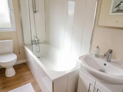 a white bathroom with a toilet and a sink at Number 15 in Carnforth