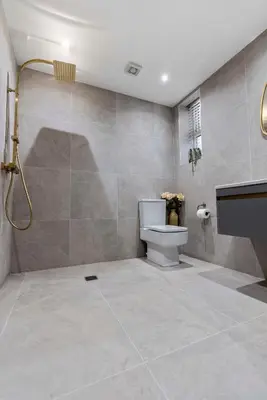 a bathroom with a shower and a toilet and a sink at The Burlington by STAMP SA in Blackpool