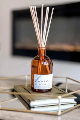 a glass jar with sticks in it on a table at The Burlington by STAMP SA in Blackpool