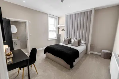 a bedroom with a bed and a desk in it at The Burlington by STAMP SA in Blackpool