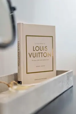 a book sitting on top of a table at The Burlington by STAMP SA in Blackpool