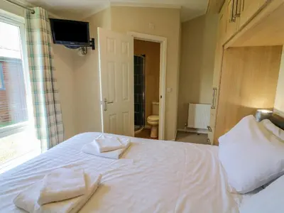 a bedroom with a bed with two towels on it at Gressingham 22 in Carnforth