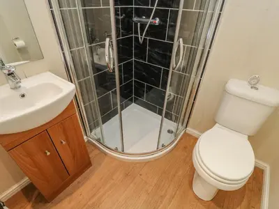 a bathroom with a shower and a toilet and a sink at Gressingham 22 in Carnforth
