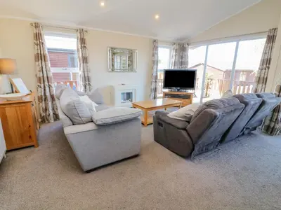 a living room with two couches and a flat screen tv at Gressingham 22 in Carnforth
