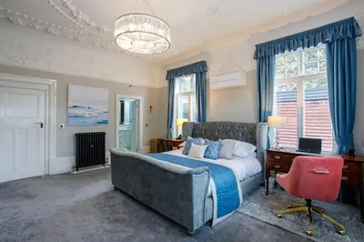 a bedroom with a bed and a desk and a chair at Tranquil Apartment in Merseyside in Liverpool