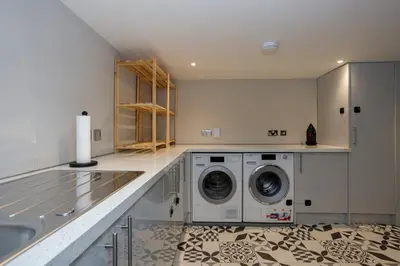 a laundry room with a washer and dryer in it at Tranquil Apartment in Merseyside in Liverpool