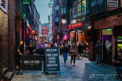 a group of people walking down a busy city street at Tranquil Apartment in Merseyside in Liverpool