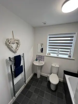 a bathroom with a toilet and a sink at Blackpool Abode - Silver Sands in Blackpool
