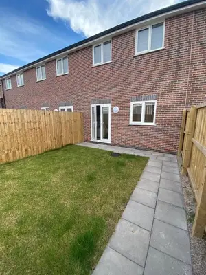 a brick house with a fence in front of it at Blackpool Abode - Silver Sands in Blackpool