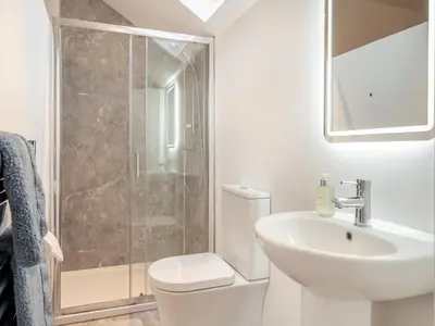 a bathroom with a shower and a toilet and a sink at The Granary in Inglewhite