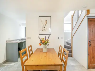 a kitchen and dining room with a wooden table and chairs at The Granary in Inglewhite
