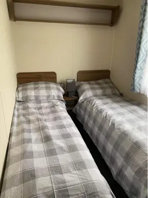 two beds sitting next to each other in a room at Adams Caravan Holidays in Morecambe