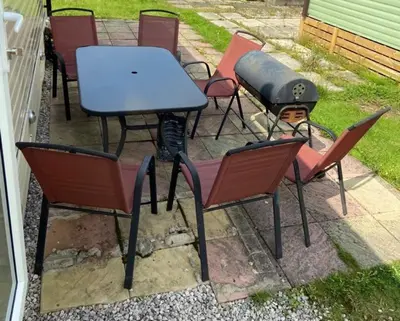 a group of chairs and a table with a grill at Adams Caravan Holidays in Morecambe