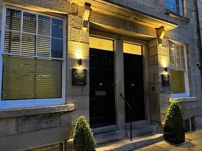 a front door of a house with lights in the window at Sun Street Aparthotel in Lancaster