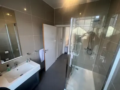 a bathroom with a shower and a sink and a toilet at Sun Street Aparthotel in Lancaster