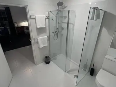 a white bathroom with a shower and a toilet at Sun Street Aparthotel in Lancaster