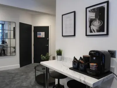 a room with a table with a coffee maker on it at Sun Street Aparthotel in Lancaster